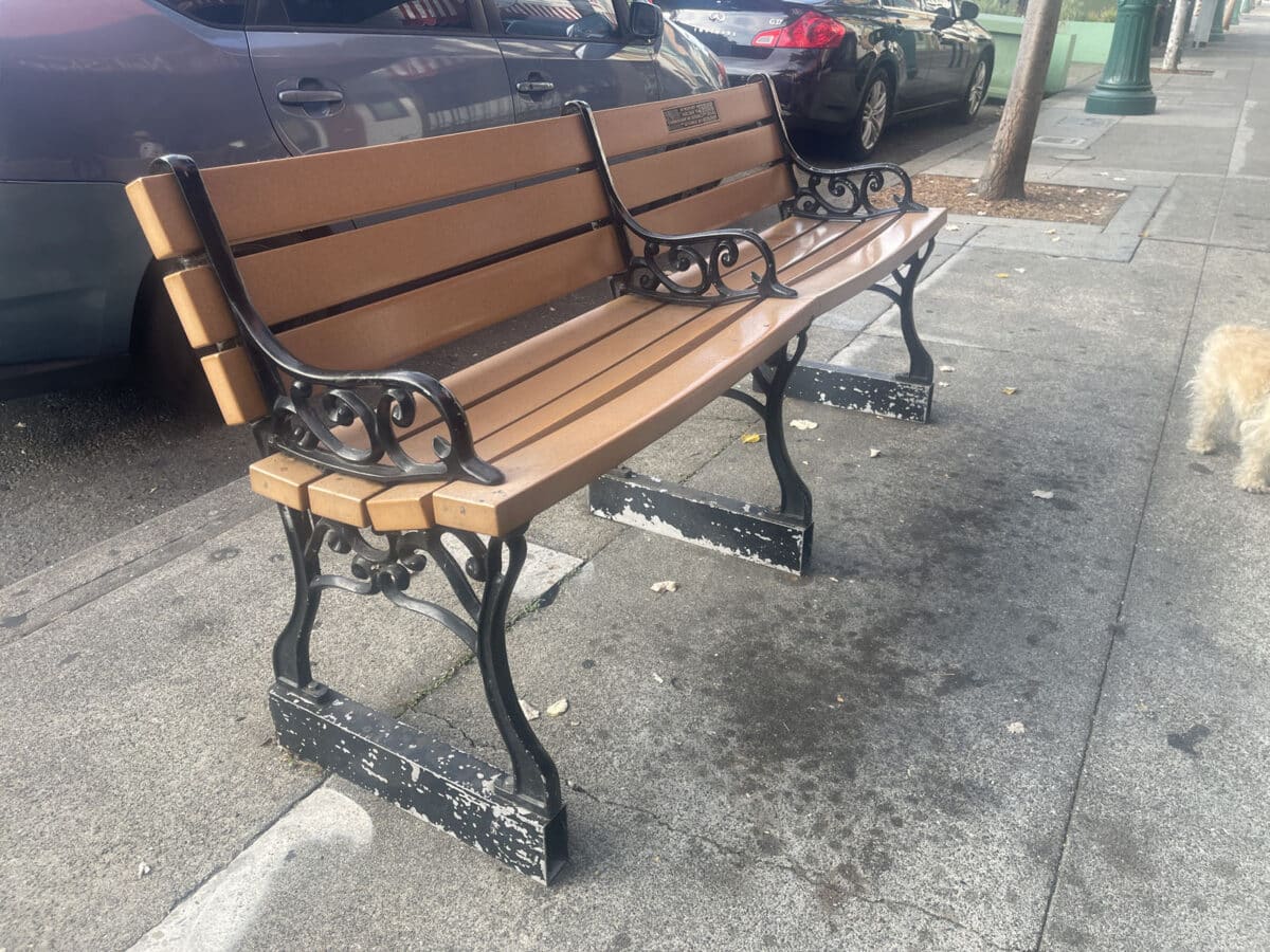 Alameda Post - A bench on a sidewalk.