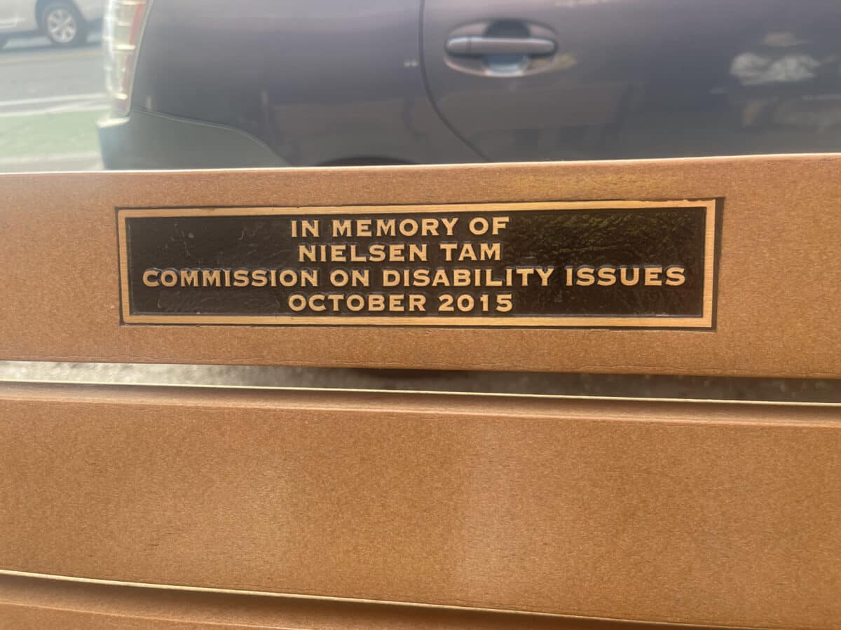 Alameda Post - A plaque on a bench that says "In Memory of Neisen Tam. Commission of disability issues. 2015." 