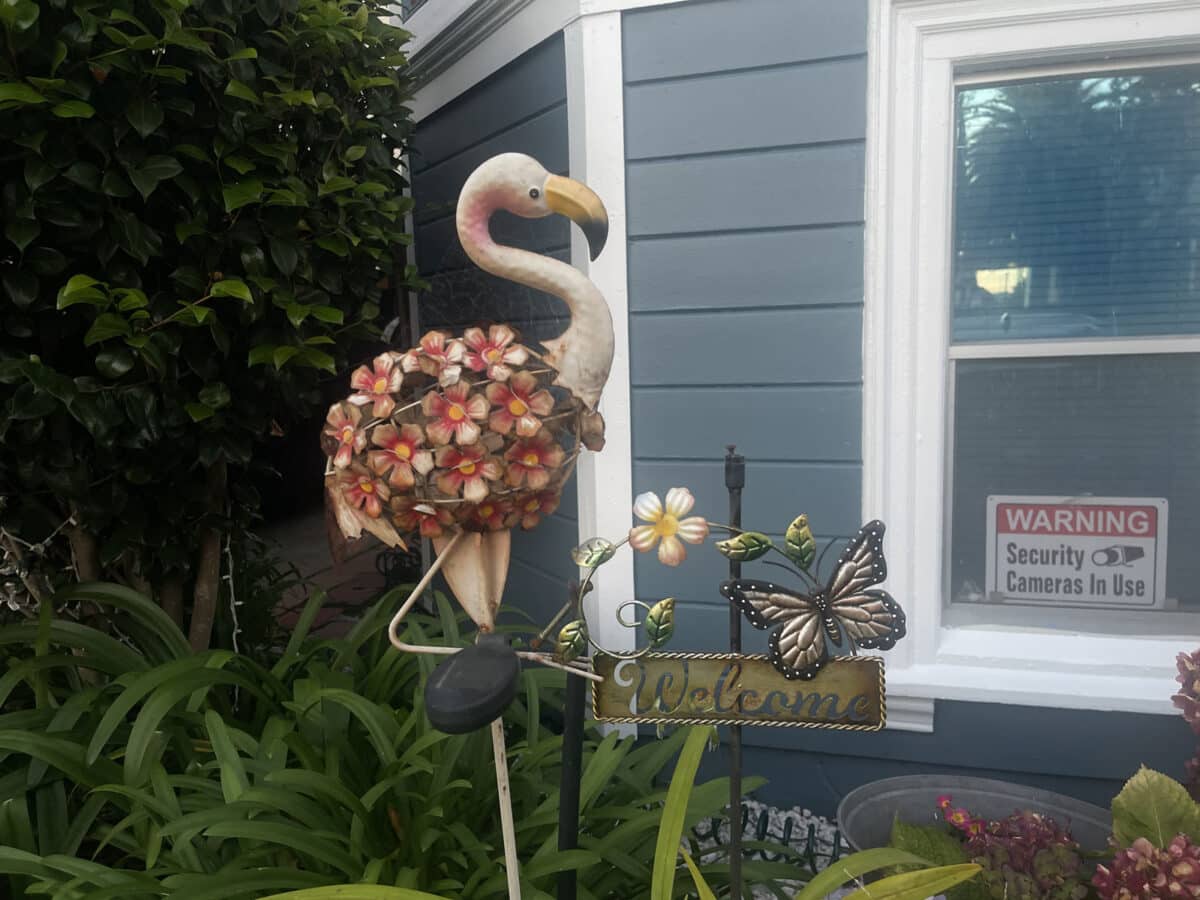 Alameda Post - A metal yard decoration in the shape of a flamingo.