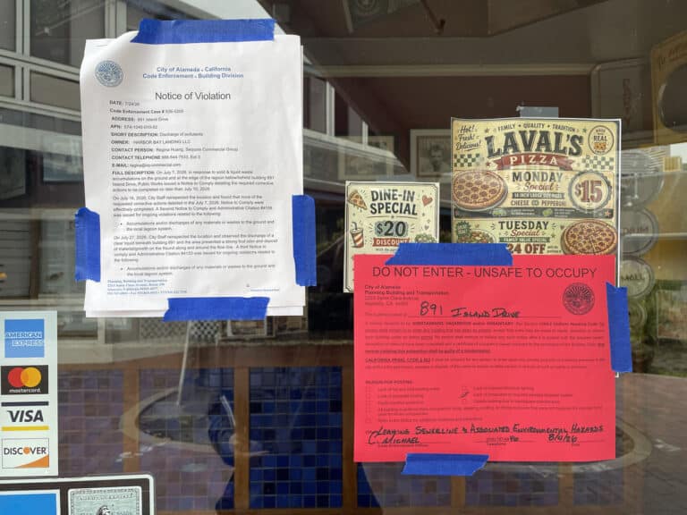 Alameda Post - The front doors to La Val’s Pizza with a large red sign that says "Do not enter. Unsafe to occupy." Another notice on the door says "Notice of Violation."