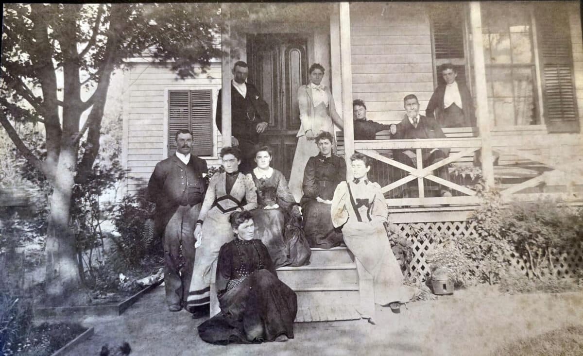 Alameda Post - A black and white family photo on a front porch.