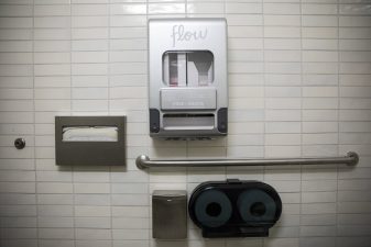 Alameda Post - Menstrual product dispenser on the wall of a public bathroom stall
