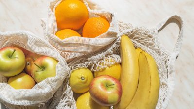 Alameda Post - Cloth reusable bags of apples, bananas, oranges, and lemons.