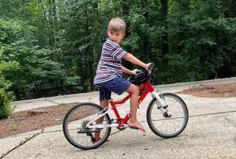 Alameda Post - A young boy on a bicycle in a driveway.