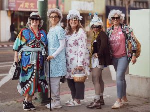 Alameda Post - Five women dressed up in Grandma outfits for GrannyCon stand at the corner of Park and Central.