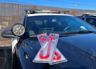 Alameda Post - a police car with locks in packages on the hood