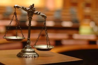 Alameda Post - The scales of justice in a courtroom.