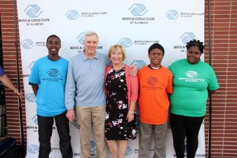 Alameda Post - Don Sherratt stands with others in a group photo in front of a backdrop that says "Boys & Girls Club of Alameda"