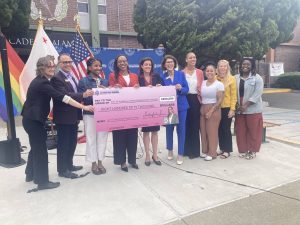 Alameda Post - Ten people stand around a large check for $850,000 for safety improvements in Alameda and smile.