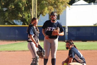 Alameda Post - Encinal softball players huddle in the field during a playoff game