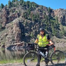 Alameda Post - Jenn Levine stands next to her bike in the Rockies