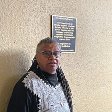 Alameda Post - Dr. Ardella Dailey stands in front of the plaque dedicating a preschool program to her