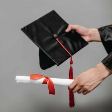 Alameda Post - Alameda post - hands hold a graduation cap and diploma