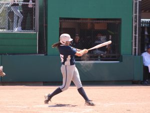 Alameda Post - a softball player swings a bat