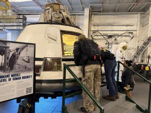 Alameda Post - Visitors peer into an Apollo command capsule aboard the U.S.S. Hornet museum.
