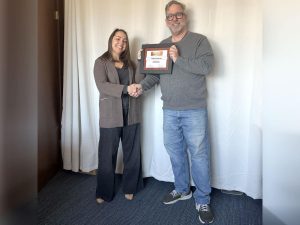 Alameda Post - Publisher Adam Gillitt presents Managing Editor Kelsey Goeres with her certificate