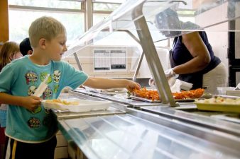 Alameda Post - student being served healthy meal in cafeteria